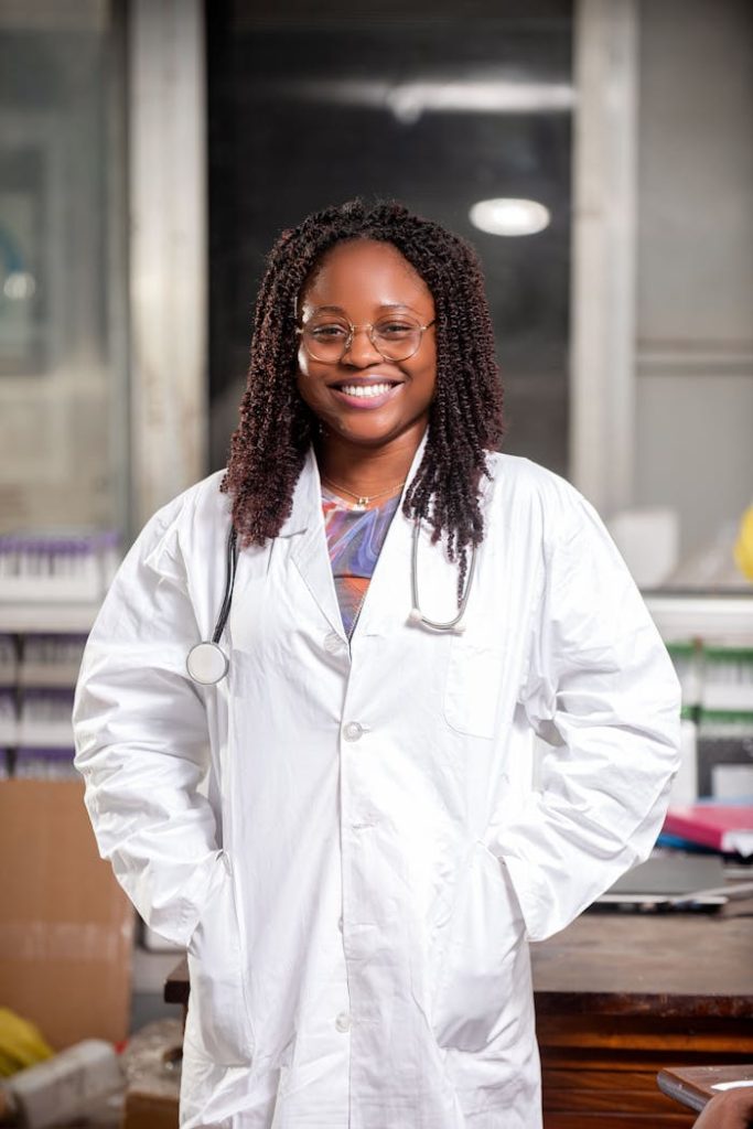 pexels photo 19218034 Portrait of a smiling female doctor with a stethoscope in a lab coat, standing indoors.